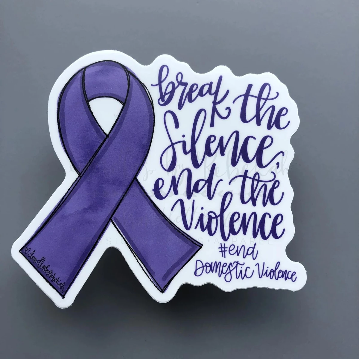 Purple awareness ribbon with a message to end domestic violence