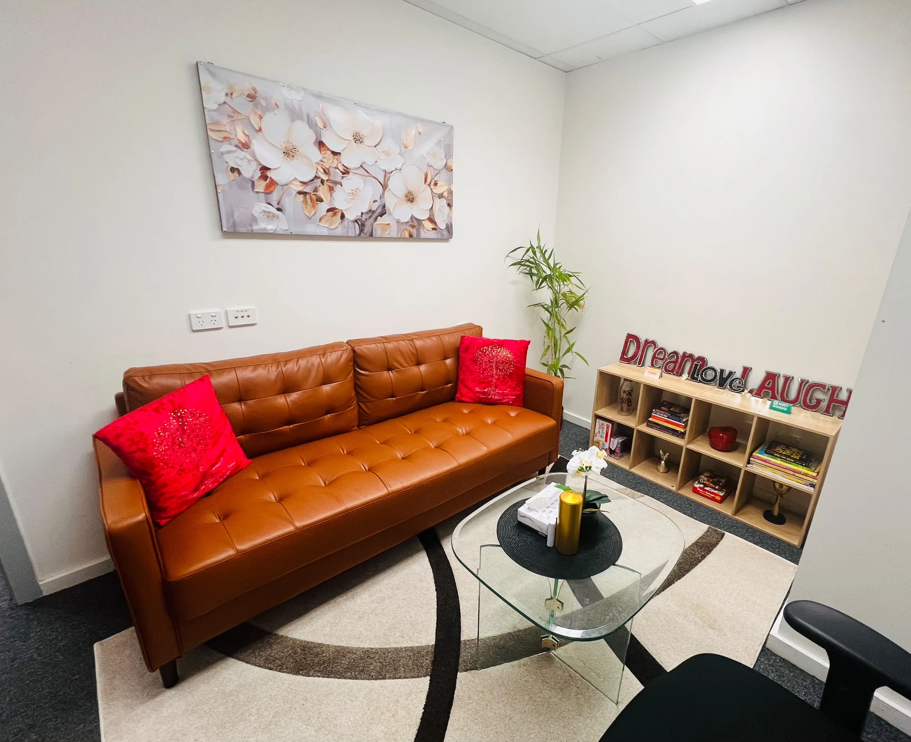 A warm brown sofa and soft furnishings in the Campsie counselling room