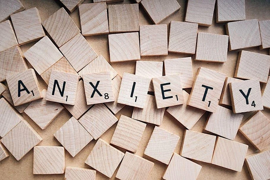 Wooden letter tiles spelling ANXIETY