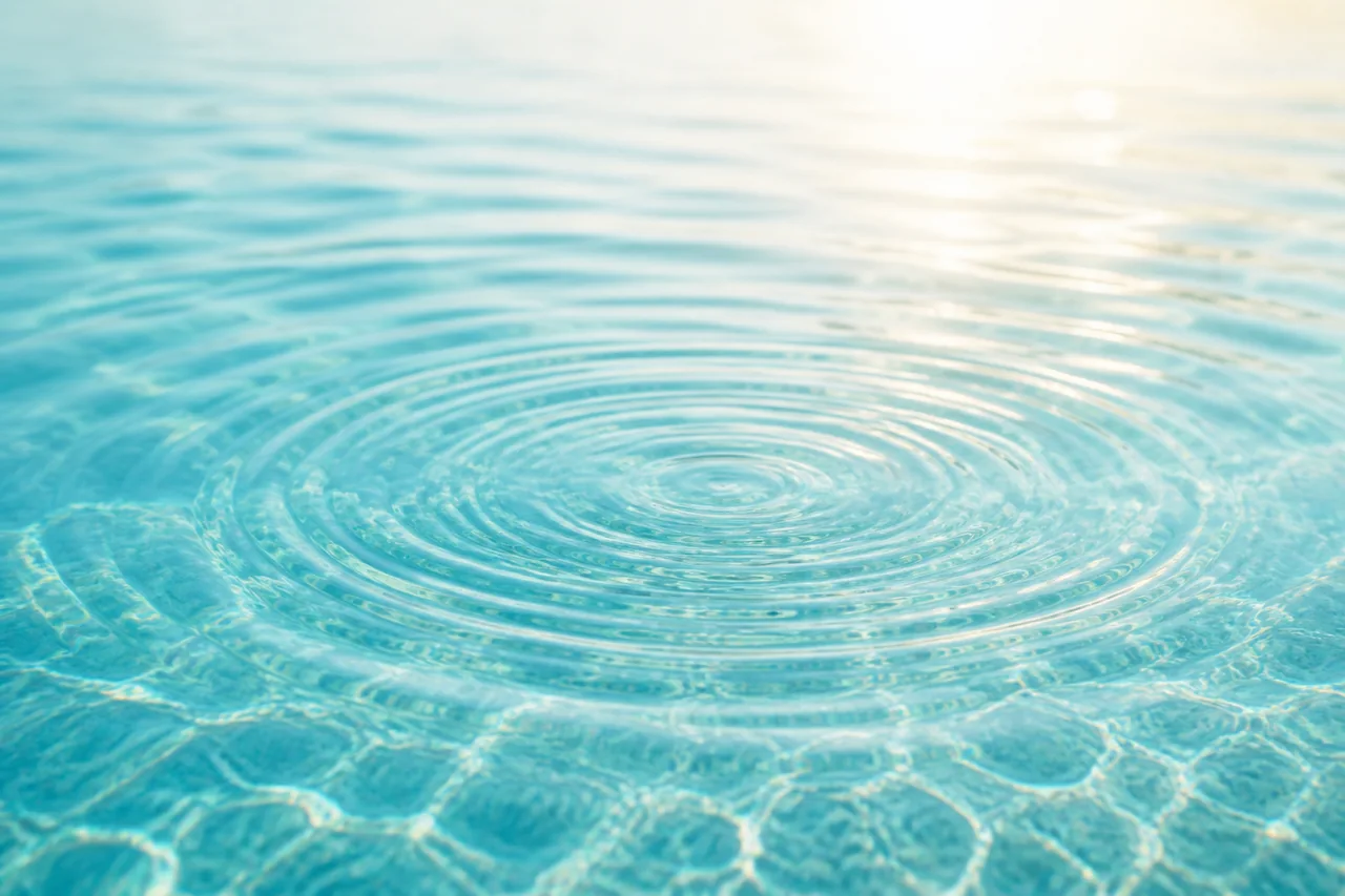 Gentle ripples moving across clear aqua water