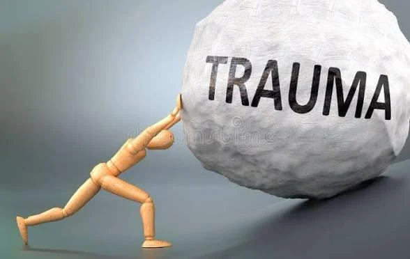A wooden figure pushing a boulder labelled TRAUMA uphill